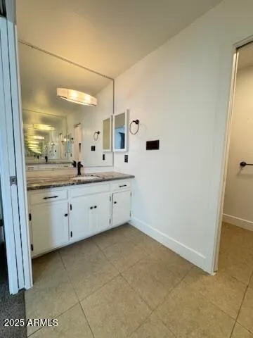 a bathroom with a double vanity sink and mirror