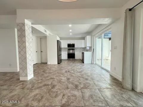 a view of a hallway with a kitchen