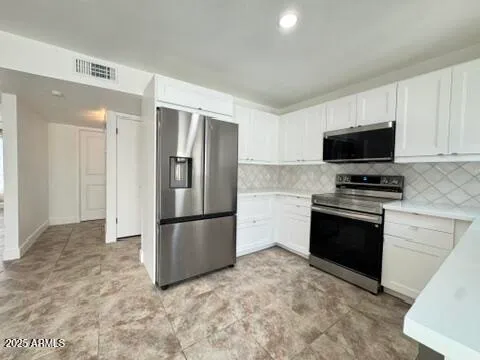 a kitchen with a refrigerator stove and microwave