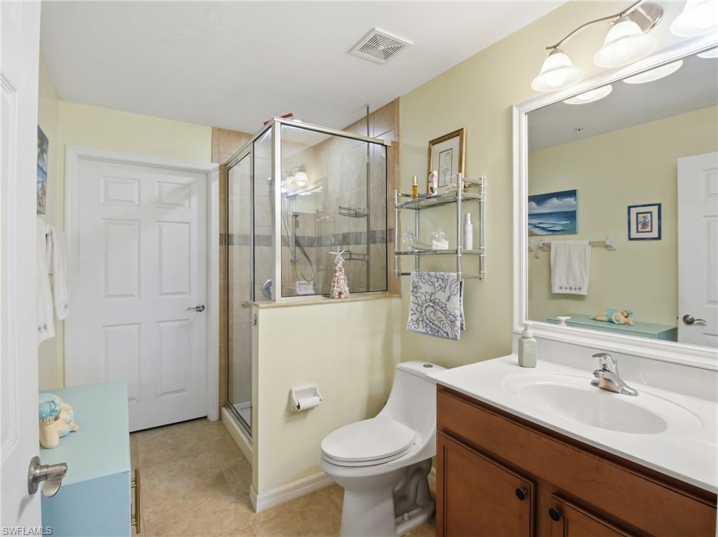 20161 Bravada Street, Unit 2 Estero, FL 33928 - Photo 17 of 34 Full bathroom with vanity, a stall shower, and light tile patterned floors