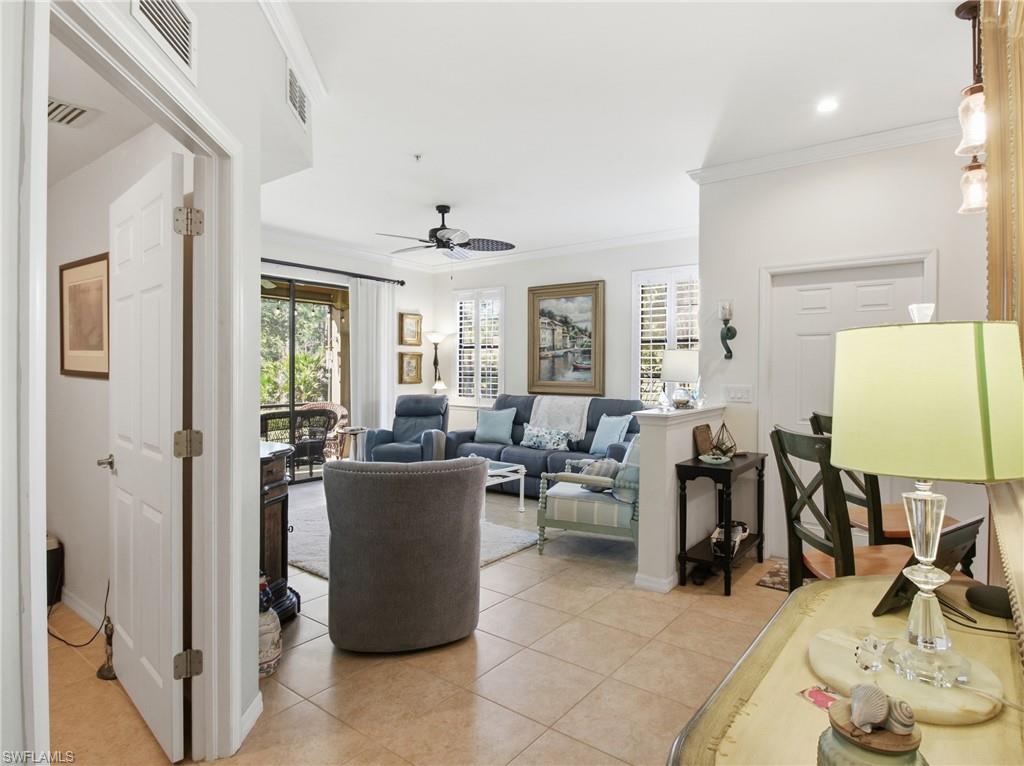 20161 Bravada Street, Unit 2 Estero, FL 33928 - Photo 5 of 34 Living area with ornamental molding, plenty of natural light, a ceiling fan, and light tile patterned floors