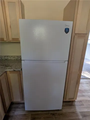 a kitchen with granite countertop a stove a sink and a microwave