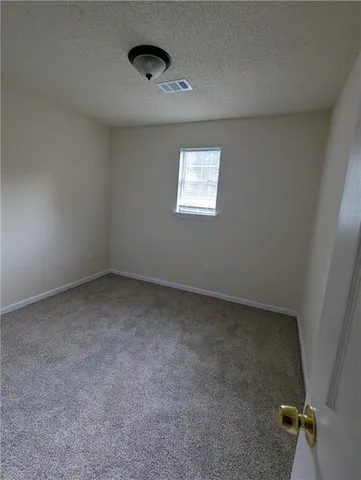 a view of an empty room and closet area