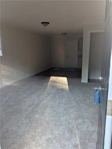a room with granite countertop a sink cabinets and wooden floor