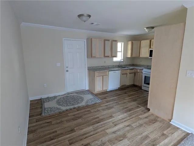 a kitchen with stainless steel appliances granite countertop a refrigerator a stove and a sink