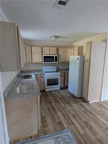 a kitchen with granite countertop a stove and a microwave