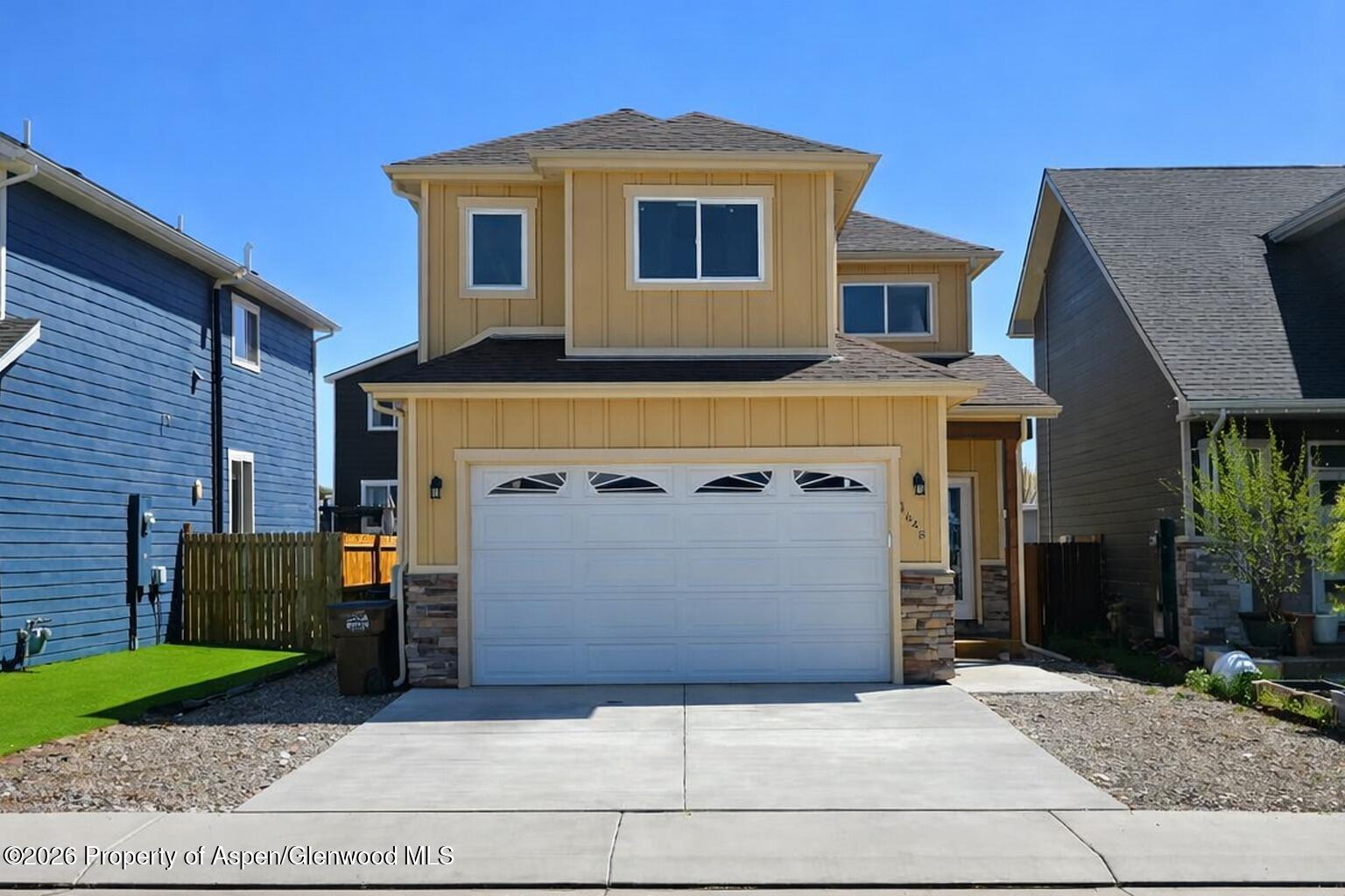 1648 Arabian Avenue Rifle, CO 81650 - Photo 1 of 15 a front view of a house with a yard and garage