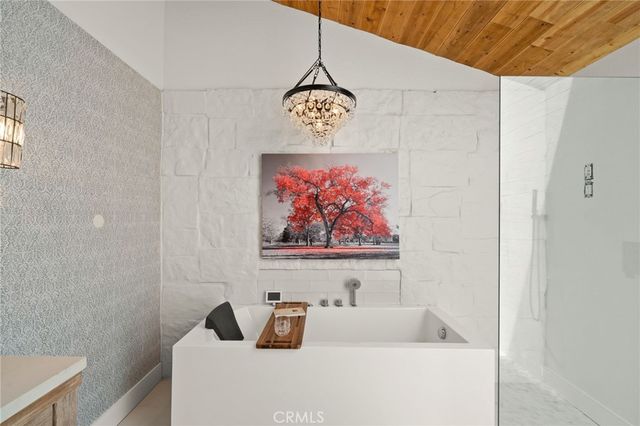 a bathroom with a bathtub and shower