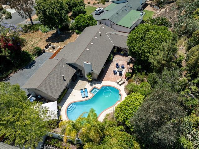 an aerial view of house with yard swimming pool and outdoor seating