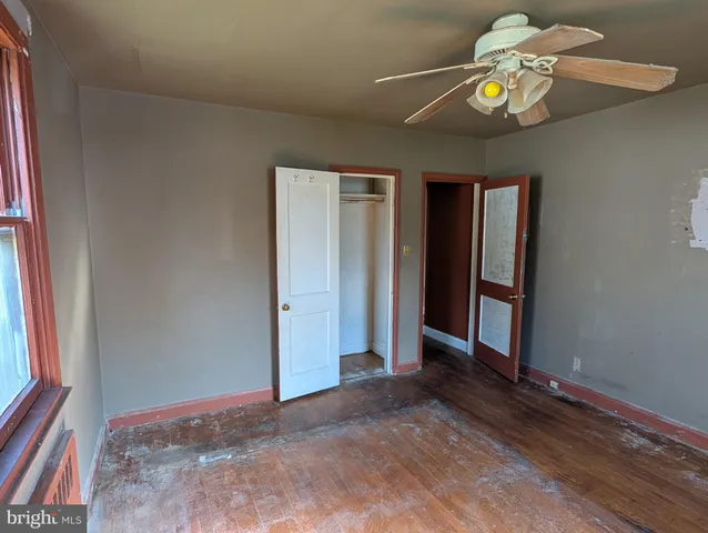 wooden floor in an empty room with a window