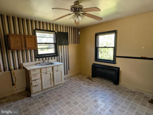 a room with sink a bed and a window