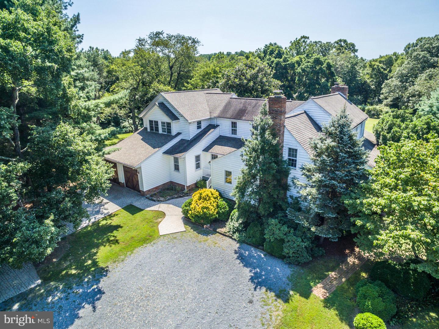 an aerial view of a house with a yard swimming pool and outdoor seating
