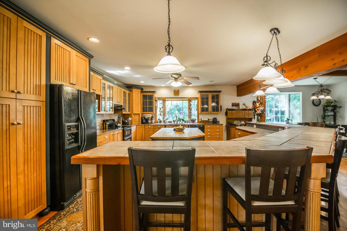 3900 Chaneyville Road Owings, MD 20736 - Photo 12 of 30 a kitchen with stainless steel appliances a dining table chairs stove and refrigerator