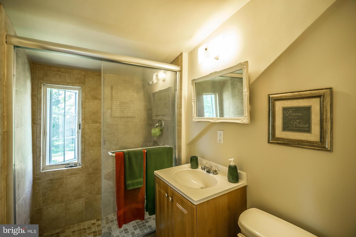 3900 Chaneyville Road Owings, MD 20736 - Photo 28 of 30 a bathroom with a toilet sink and mirror