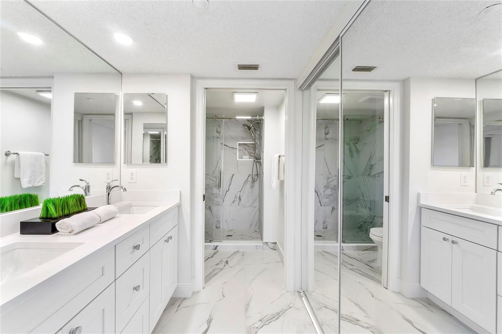 7763 Southampton Terrace, Unit 102 Tamarac, FL 33321 - Photo 18 of 73 a bathroom with a double vanity sink mirror and shower