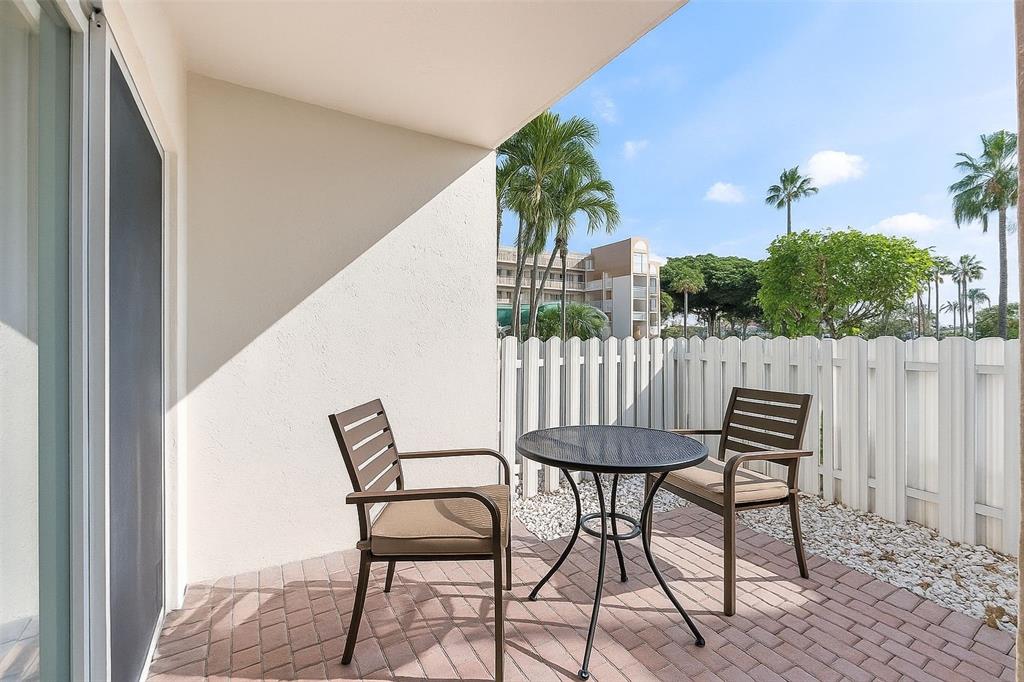 7763 Southampton Terrace, Unit 102 Tamarac, FL 33321 - Photo 6 of 73 a view of a chairs and table in patio