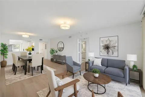 a kitchen with stainless steel appliances white cabinets a sink a stove a refrigerator and a white stove