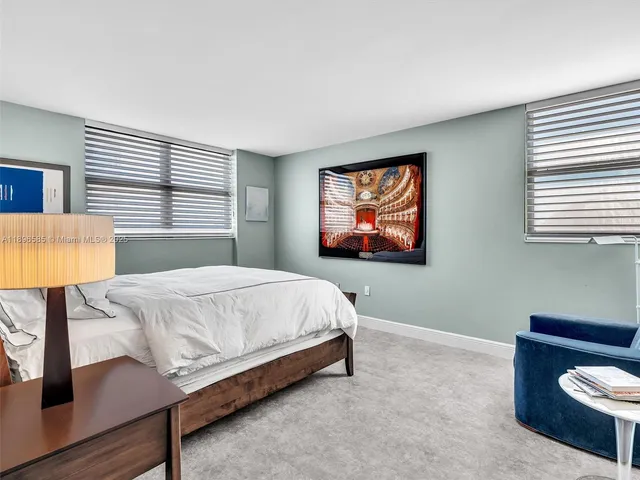 a bedroom with a bed and a lamp on table