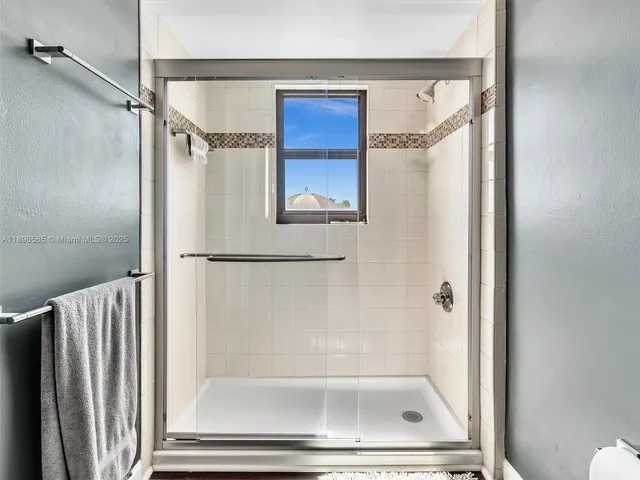 a bathroom with a glass shower door