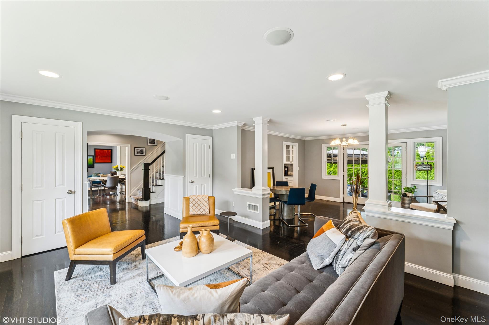 15 Flamingo Road East Hills, NY 11576 - Photo 14 of 41 Living area featuring crown molding, stairway, dark wood-style floors, recessed lighting, and decorative columns