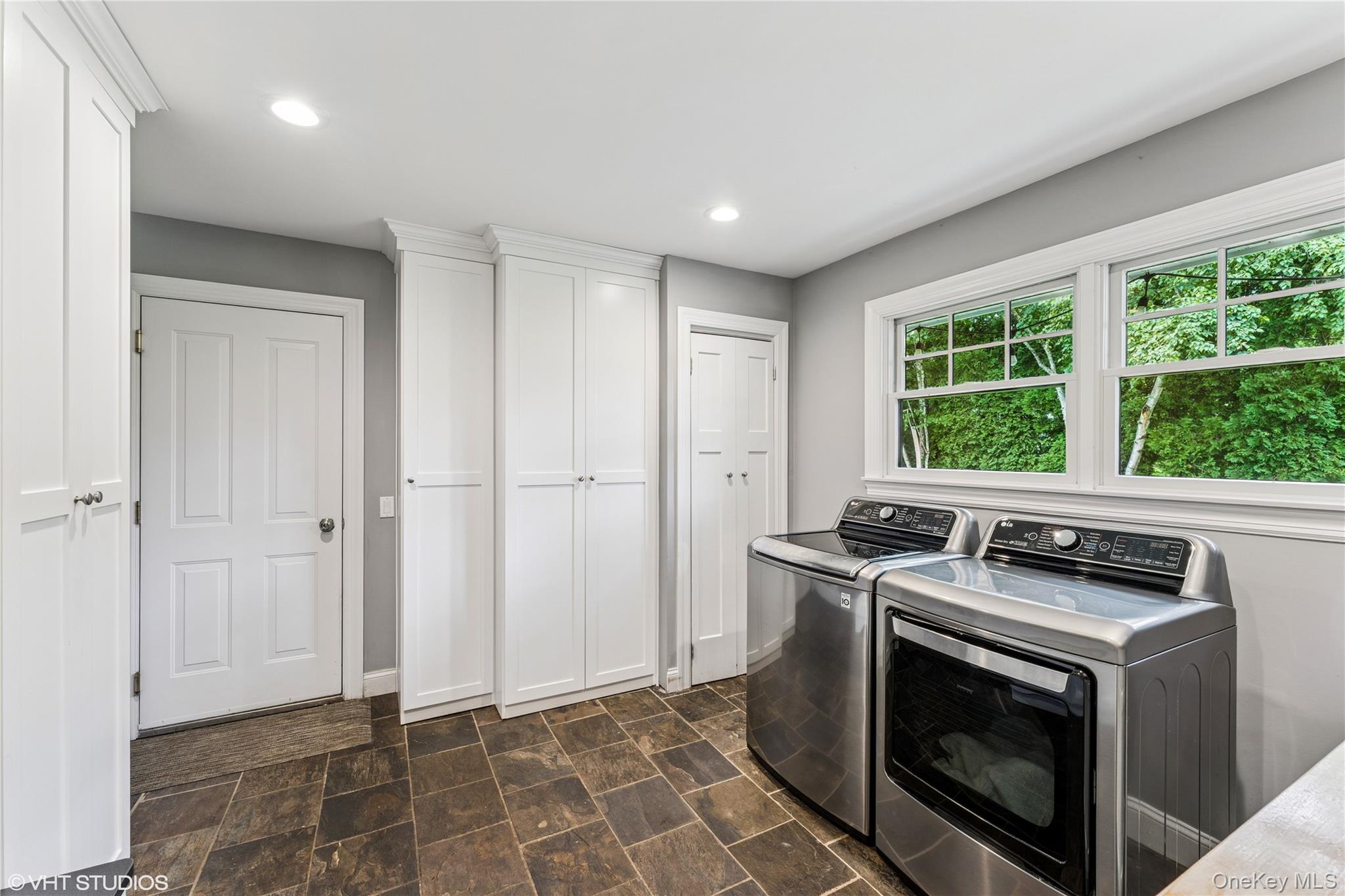 15 Flamingo Road East Hills, NY 11576 - Photo 18 of 41 Laundry room with washing machine and dryer, stone finish floors, and recessed lighting