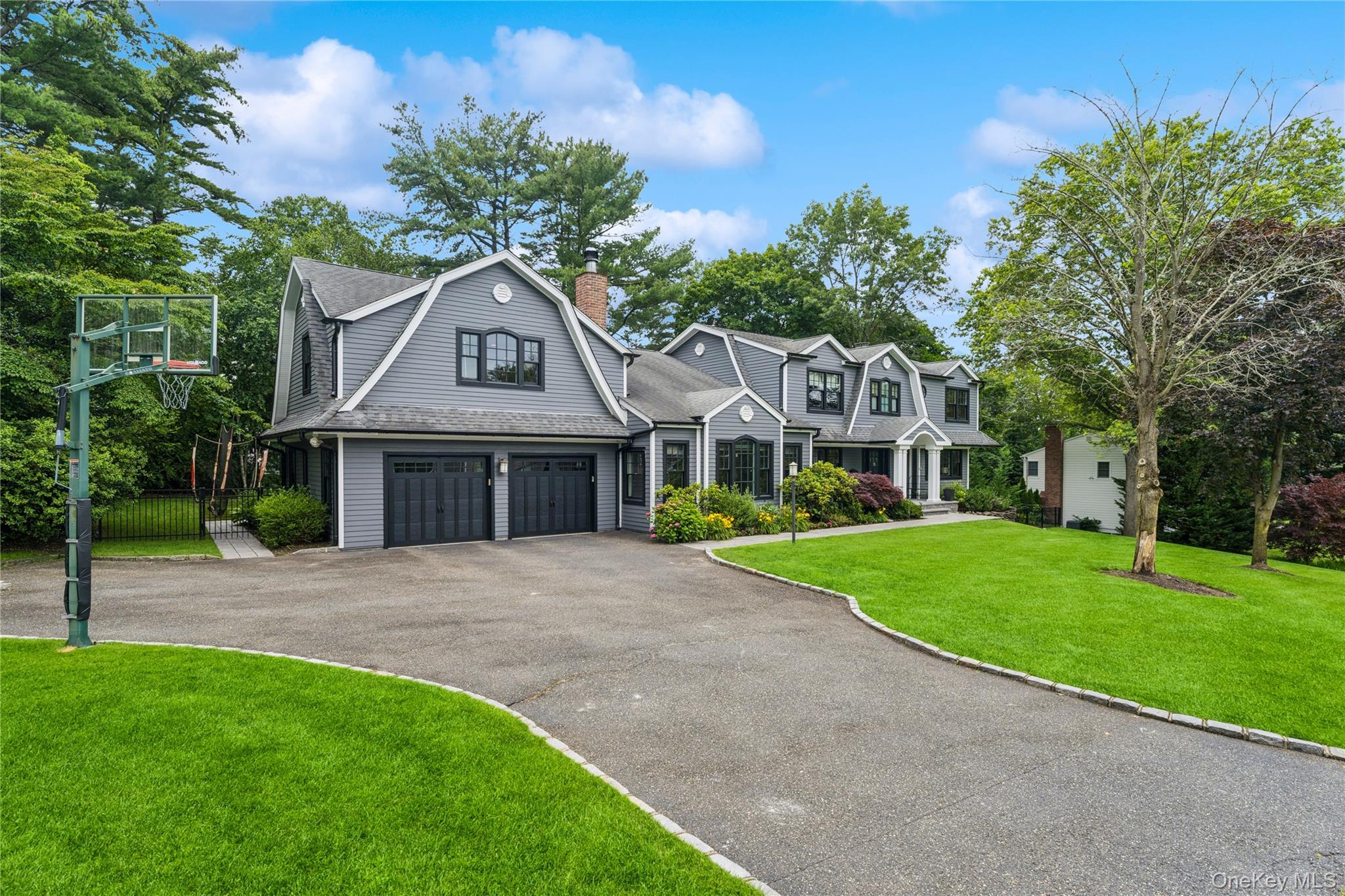 15 Flamingo Road East Hills, NY 11576 - Photo 2 of 41 View of front of home with a gambrel roof, asphalt driveway, roof with shingles, and a chimney
