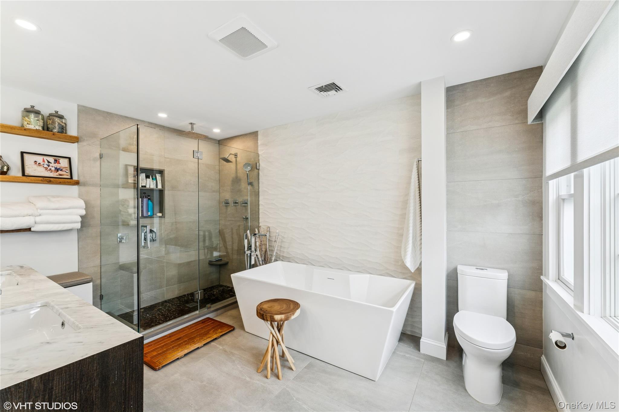 15 Flamingo Road East Hills, NY 11576 - Photo 24 of 41 Bathroom with tile walls, double vanity, a soaking tub, a shower stall