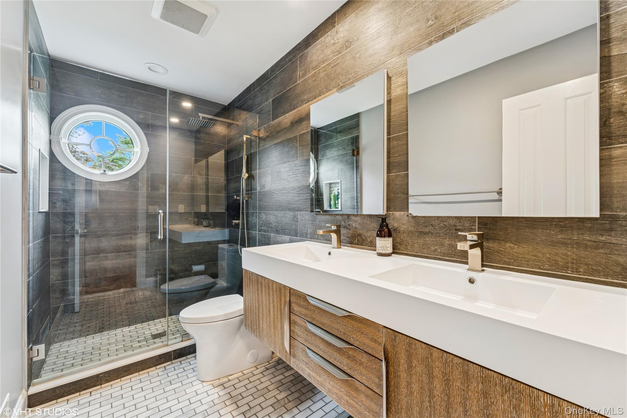 15 Flamingo Road East Hills, NY 11576 - Photo 28 of 41 Bathroom with a shower stall, double vanity, light tile flooring, tile walls, and backsplash