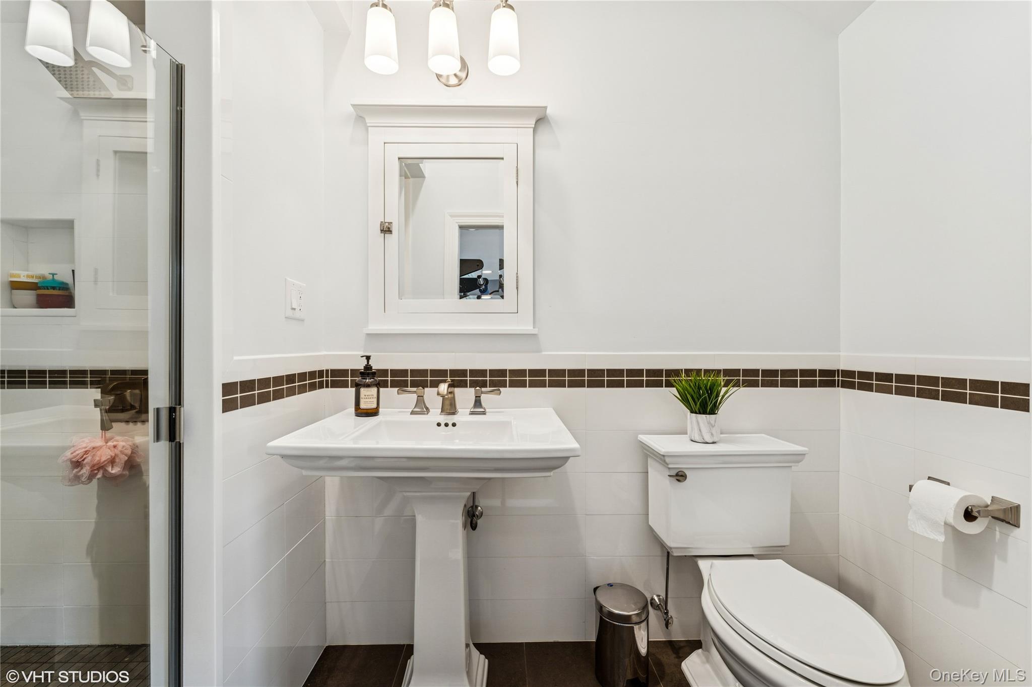 15 Flamingo Road East Hills, NY 11576 - Photo 31 of 41 Full bath with tile walls, wainscoting, and a stall shower