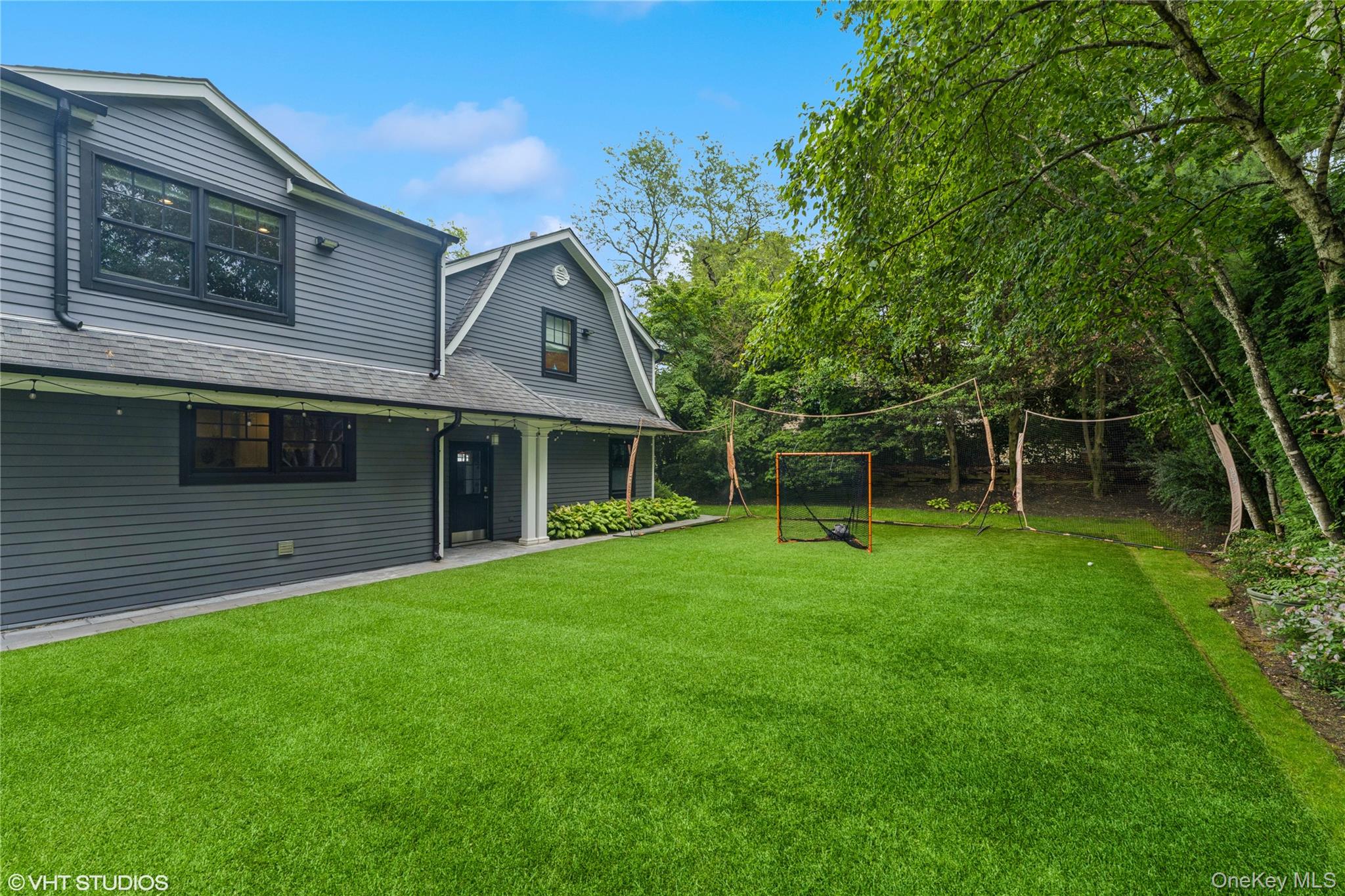 15 Flamingo Road East Hills, NY 11576 - Photo 35 of 41 View of green lawn with covered porch