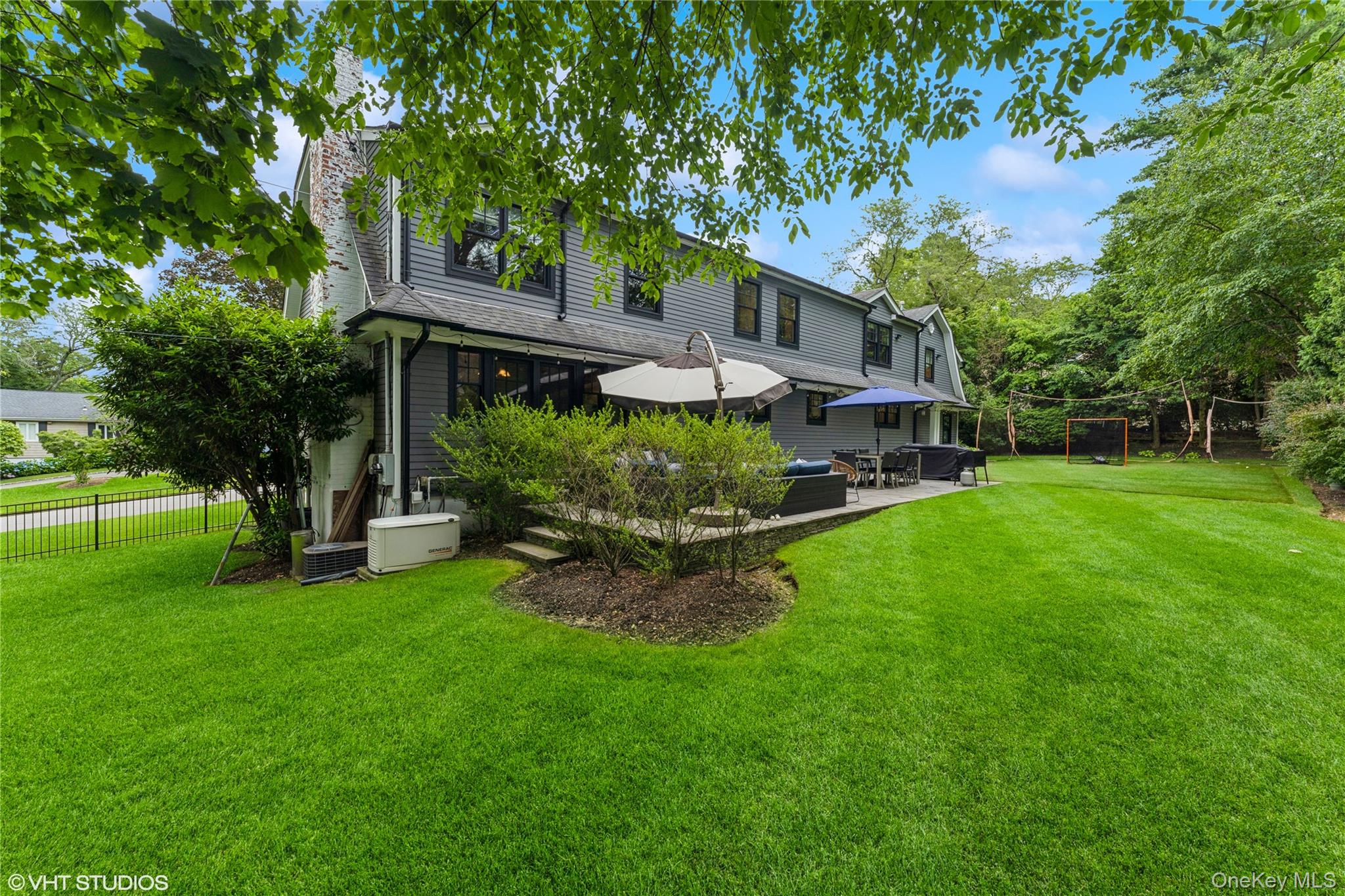 15 Flamingo Road East Hills, NY 11576 - Photo 37 of 41 Rear view of property with a patio, a chimney, and an outdoor hangout area