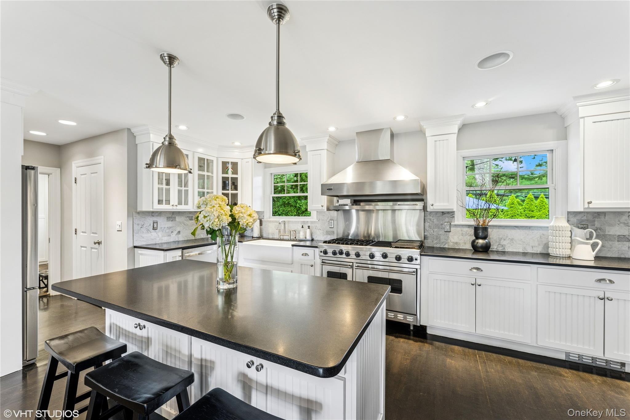 15 Flamingo Road East Hills, NY 11576 - Photo 4 of 41 Kitchen with wall chimney range hood, a breakfast bar, dark wood finished floors, white cabinets, and recessed lighting