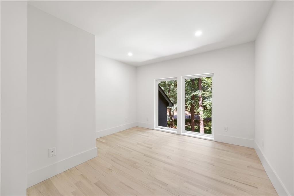 8120 Ball Mill Road Northeast Atlanta, GA 30350 - Photo 66 of 95 an empty room with wooden floor and windows