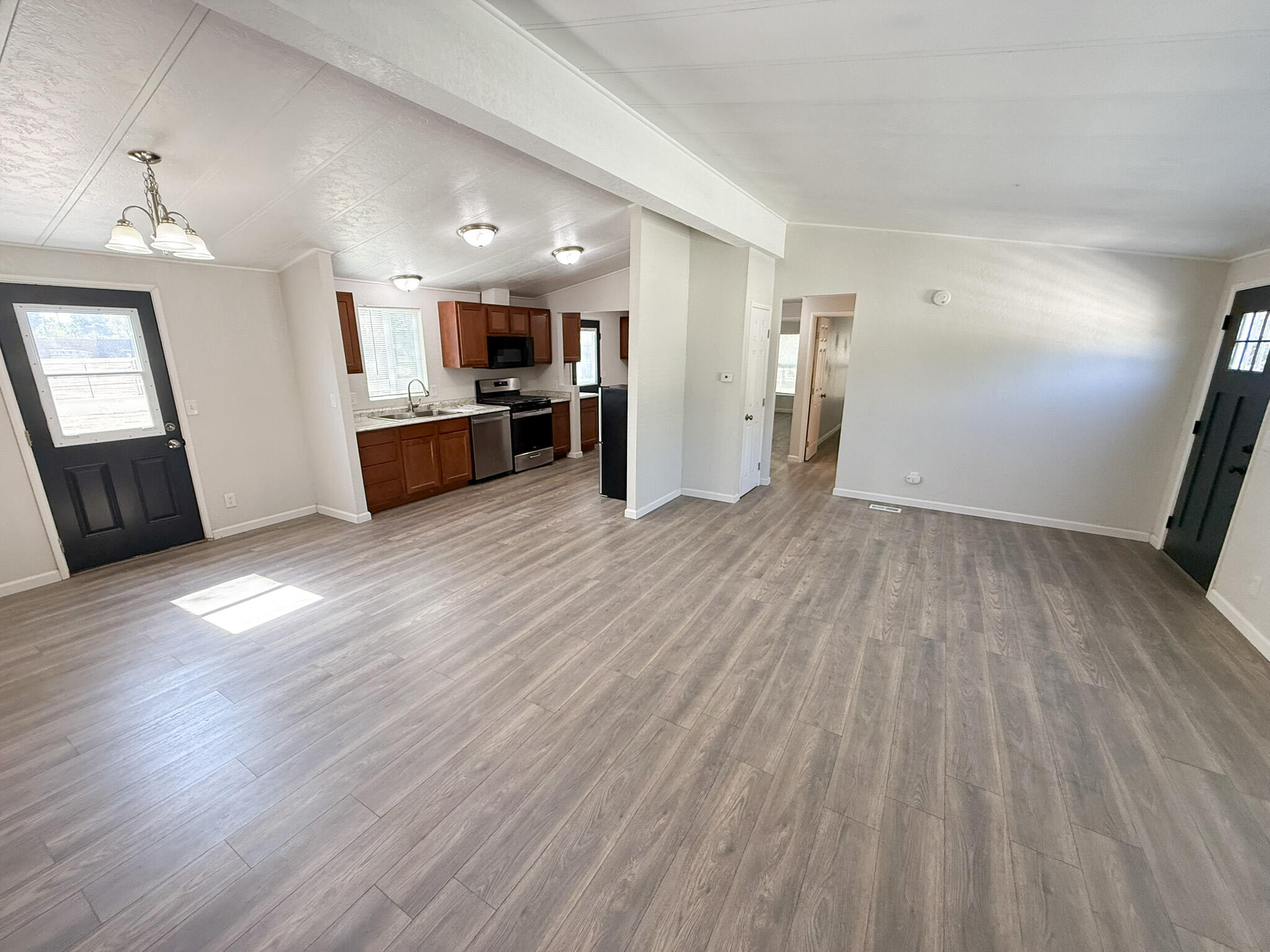 28495 Roan Ranch Road Menifee, CA 92585 - Photo 8 of 40 a view of a kitchen with wooden floor and electronic appliances