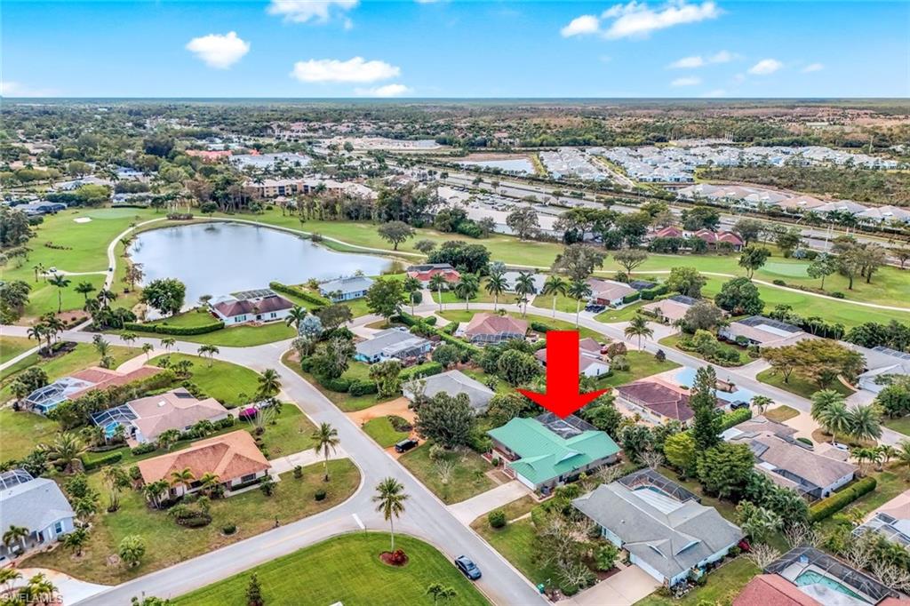 Aerial view of property and surrounding area with a nearby body of water, nearby suburban area, and nearby Hibiscus Golf Course