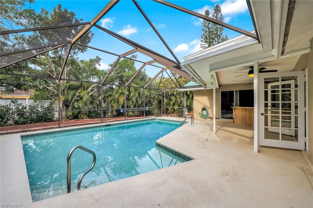 196 Baltusrol Drive Naples, FL 34113 - Photo 17 of 20 Swimming pool in screened in lanai