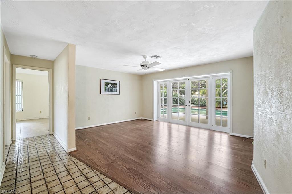 196 Baltusrol Drive Naples, FL 34113 - Photo 3 of 20 Features French doors out to pool lanai, wood floors.
