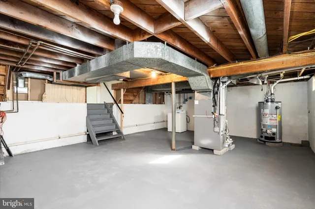 a view of water heater room with stairs