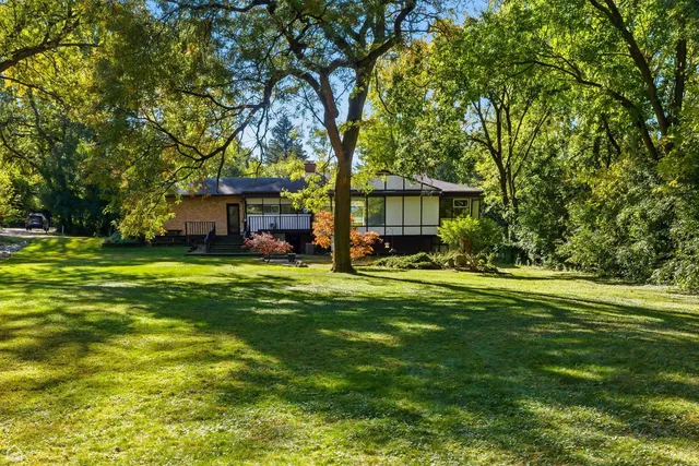 a front view of a house with a yard table and seating