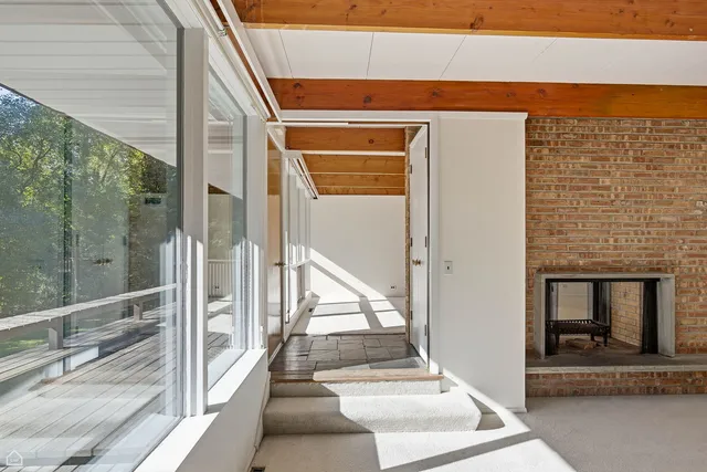 a view of staircase with a chair and a fireplace