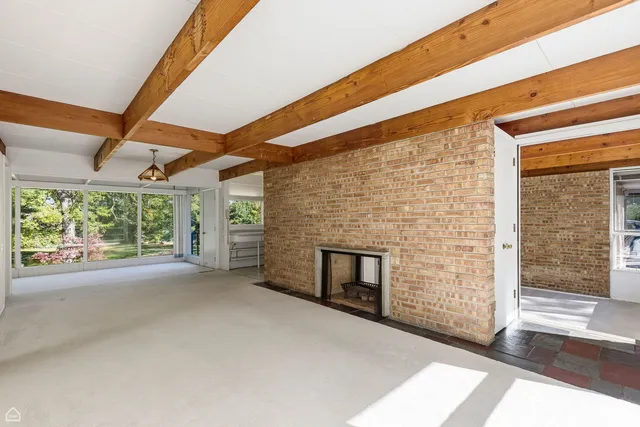 a view of empty room with windows and fireplace