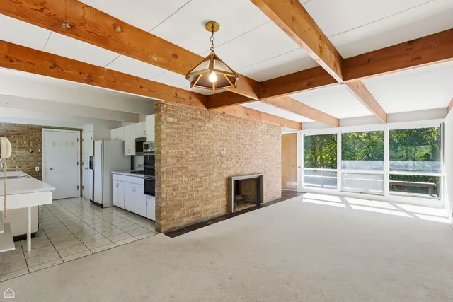 a view of a room with furniture and a window