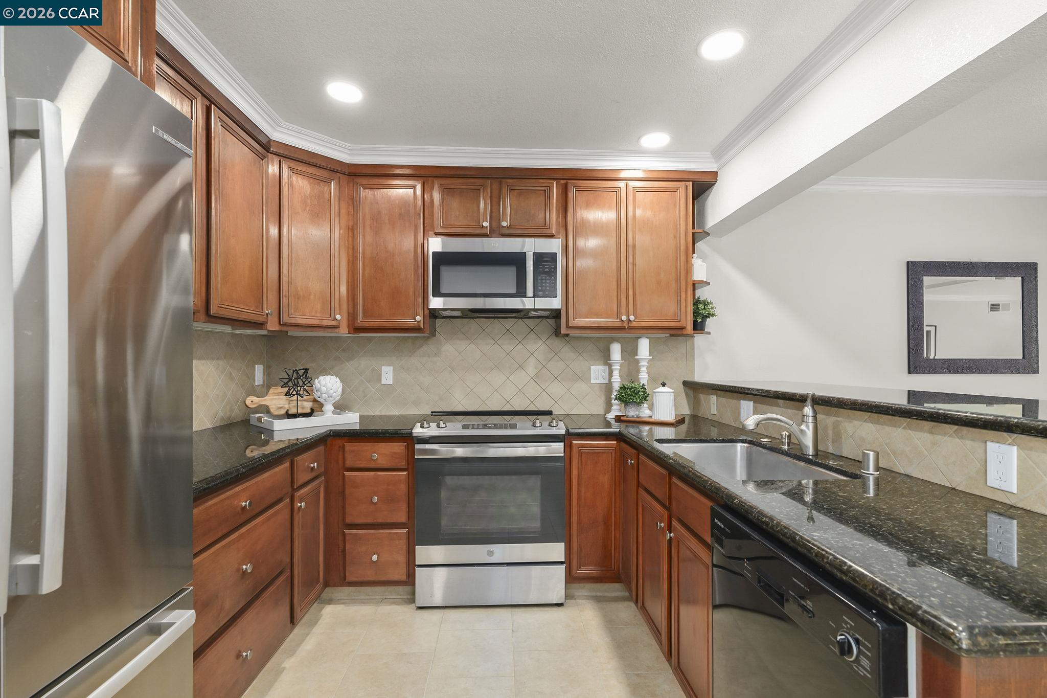 2057 Golden Rain Road, Unit 4 Walnut Creek, CA 94595 - Photo 12 of 20 a kitchen with stainless steel appliances a sink stove and microwave