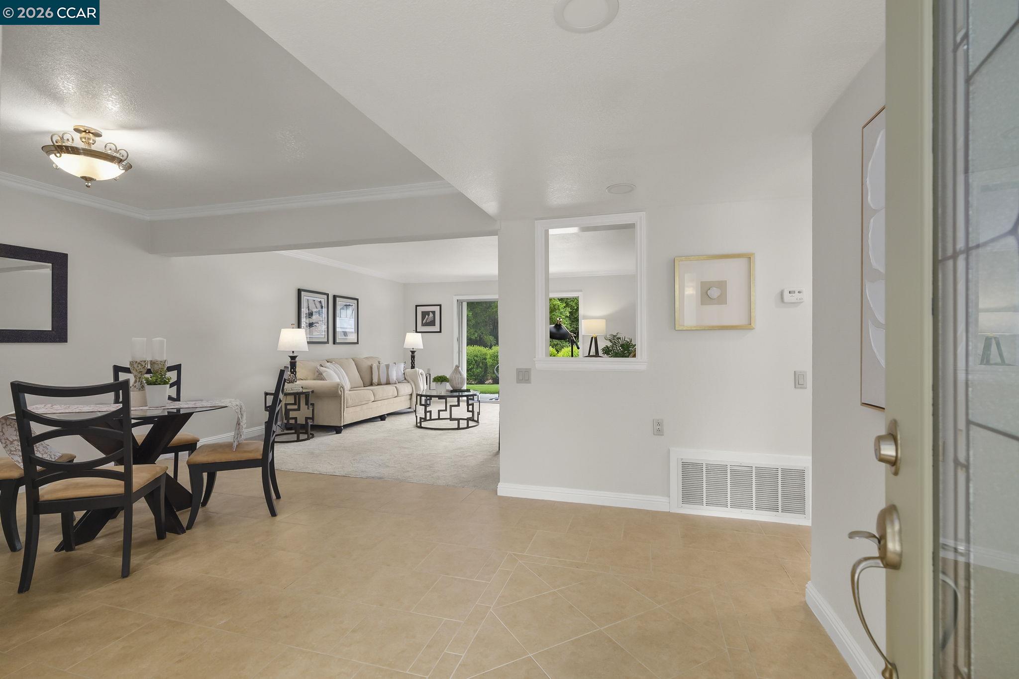 2057 Golden Rain Road, Unit 4 Walnut Creek, CA 94595 - Photo 4 of 20 a living room with furniture and a chandelier