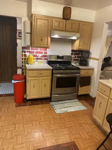 a kitchen with stainless steel appliances granite countertop a stove a sink and a refrigerator