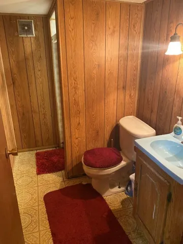a bathroom with a toilet and shower curtain