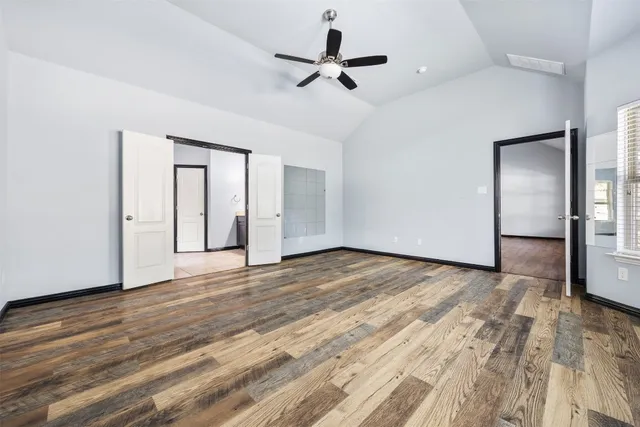 a view of a room with wooden floor and wooden floor