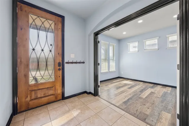 a kitchen with a stove a sink a center island and windows