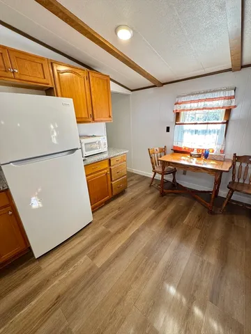 a room with wooden floor and furniture