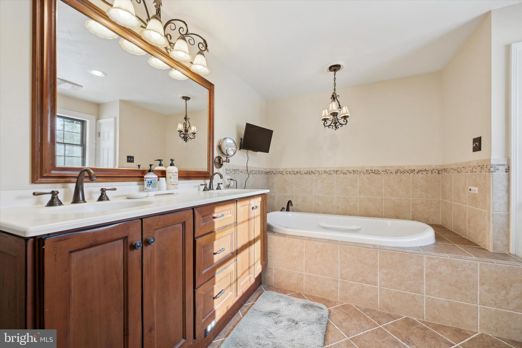 78 7 Stars Road Spring City, PA 19475 - Photo 34 of 117 a bathroom with a double vanity sink a toilet a mirror and bathtub